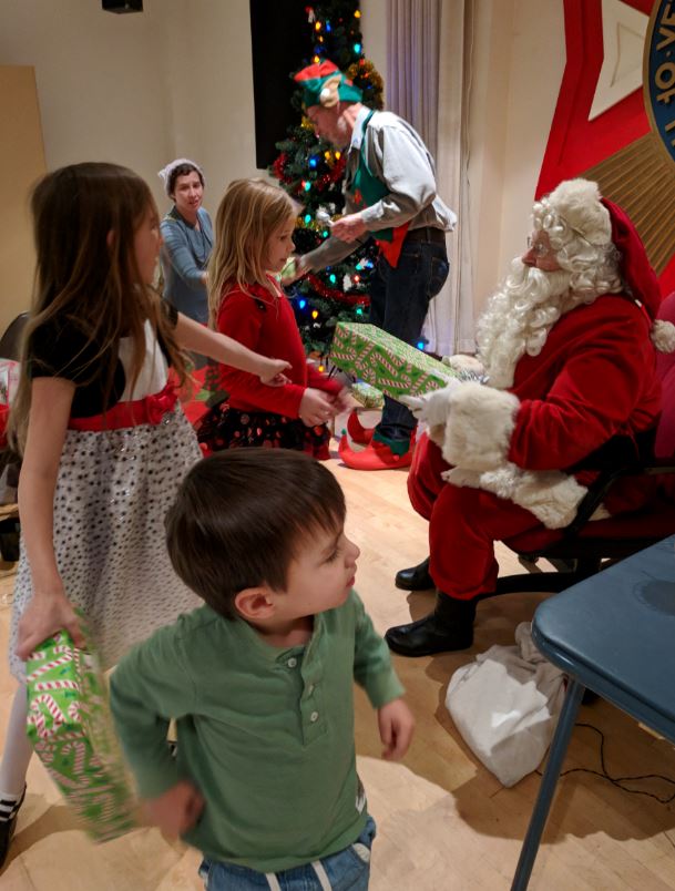The kids wait to receive their gifts from Santa.