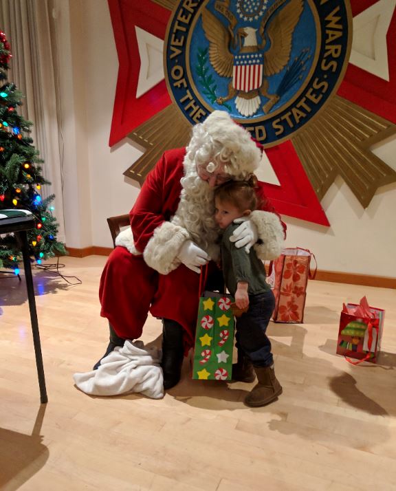 Santa gives gifts and cheer to the children of Post 3063.