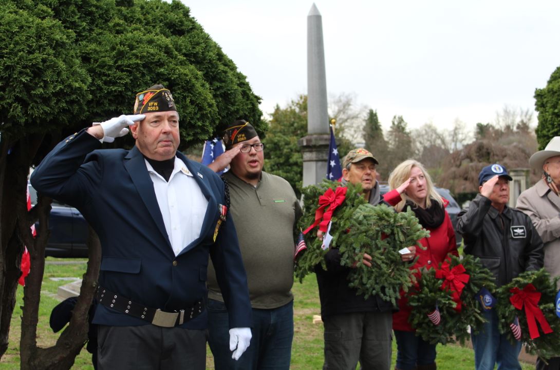 Comrades Joe Fitzgerald and Jon Guncay render a salute during the ceremony.