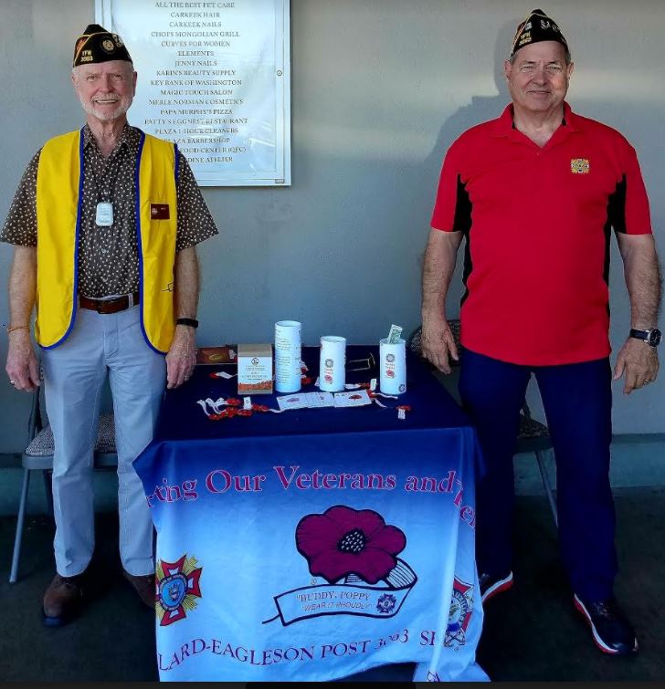 Harold Rodenberger and Joe Fitzgerald pass out Buddy Poppy pins and seeds at the QFC on Holman Road.