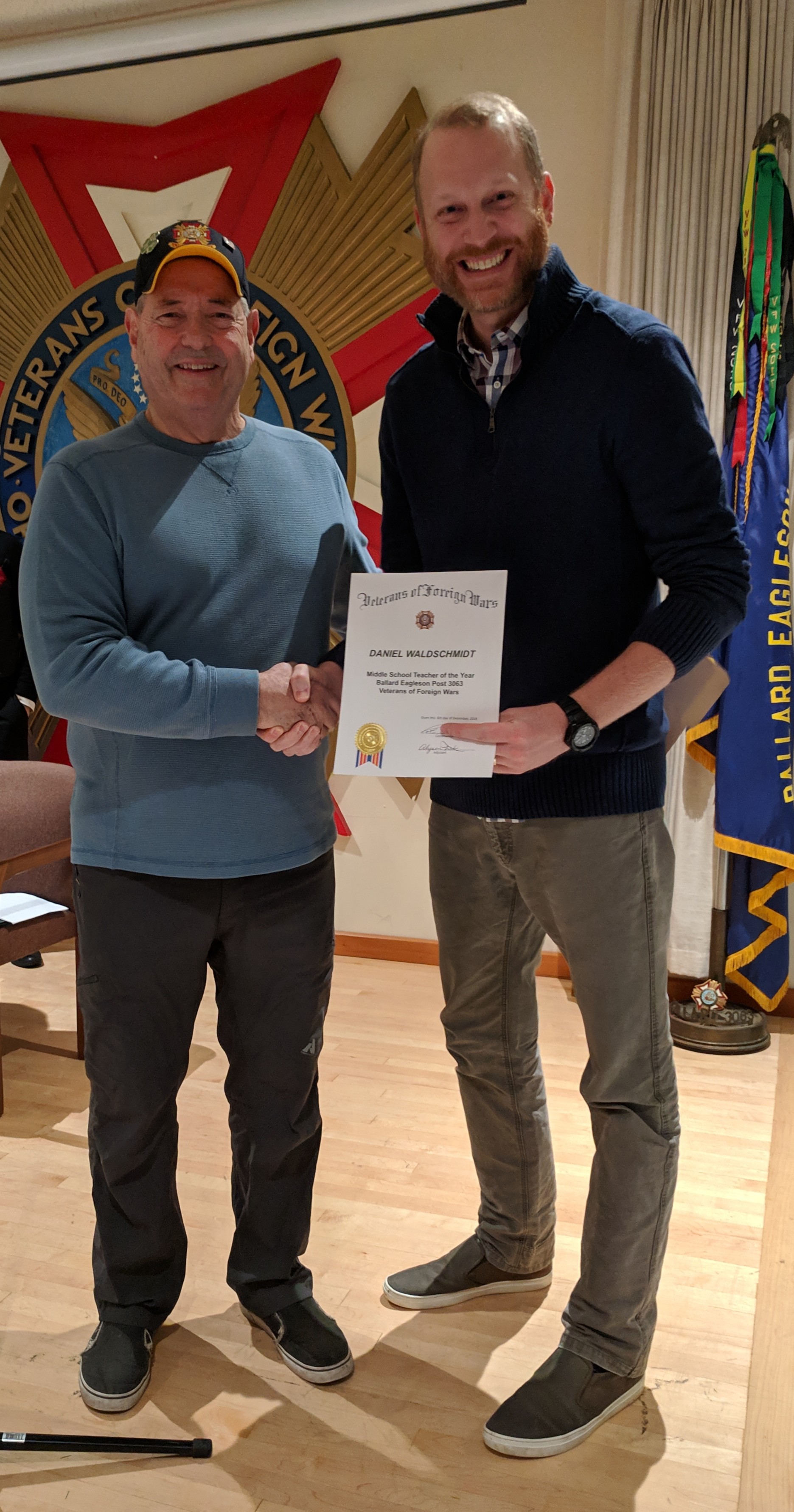 Sr. Vice Fitzgerald presents a certificate to Daniel during the holiday party.